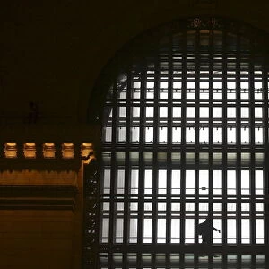 A person walks in front of a window at Grand Central Terminal in the Manhattan borough of