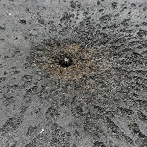 Piece of a mortar projectile is pictured on a road near the airport in Donetsk