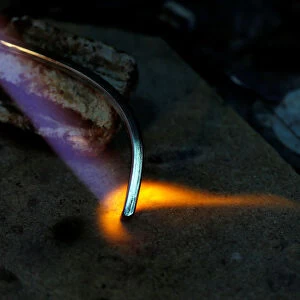 A piece of silver jewellery is seen during preparation in the workshop of goldsmith