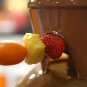 Pieces of fruits are coated with chocolate during the 2nd Chocolate Fair of Barcelona Pieces of fruits are coated with chocolate during the 2nd Chocolate Fair of Barcelona