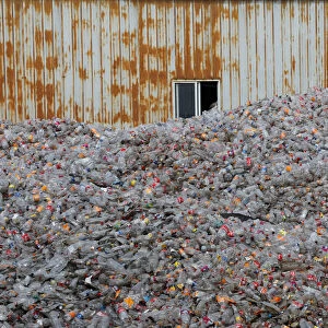 Plastic bottles are stocked to be recycled at the Weeco plastic recycling factory at the
