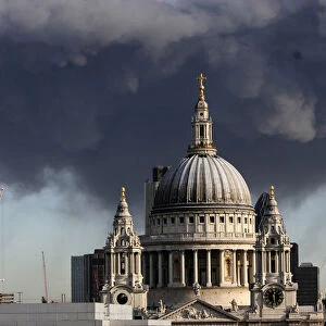 A plume of smoke hangs in the air behind St Pauls Cathedral in London