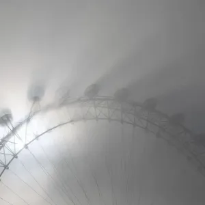 The pods on the London Eye casts shadows against a thick morning fog as the spring The pods on the London Eye casts shadows against a thick morning fog as the spring