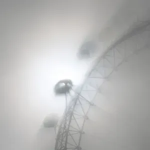 The pods on the London Eye casts shadows against a thick morning fog as the spring The pods on the London Eye casts shadows against a thick morning fog as the spring