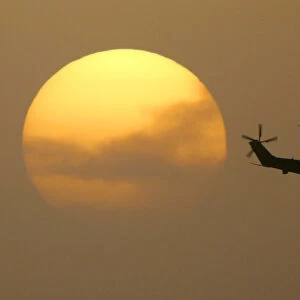 Puma helicopter flies out from the Green Zone at sunset in Baghdad