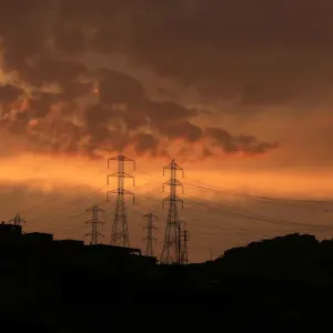 Pylons of high-tension electricity power lines are seen near houses at Villa Maria del