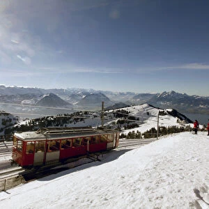 A rack railcar of Rigi Bahn railways leaves the peak of Mount Rigi near Lake Lucerne