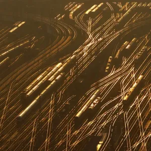 Railway tracks lead towards the main train station as the sun sets on a freezing cold Railway tracks lead towards the main train station as the sun sets on a freezing cold