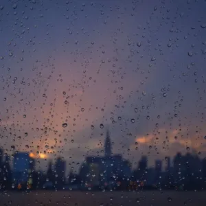 Rain is seen on a window of a ferry boat as it passes midtown Manhattan and the Empire Rain is seen on a window of a ferry boat as it passes midtown Manhattan and the Empire