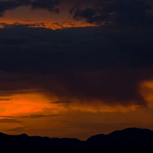Rain starts to fall over the Sheep Mountain Range north of Las Vegas at sunset