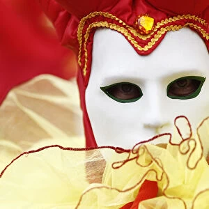 A reveller participates in a masked ball during celebrations for the Carnival of