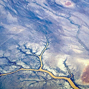 River systems can be seen flowing near sand dunes in outback Queensland