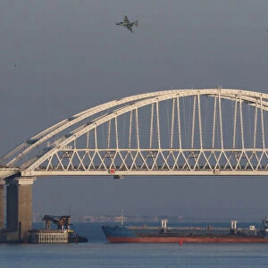 Russian jet fighters fly over a bridge connecting the Russian mainland with the Crimean