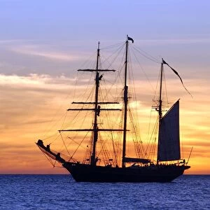 Sail training barquentine ship Leeuwin sails in the Indian Ocean at sunset off the