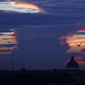 Saint Peters square is silhouetted during a sunset in Rome
