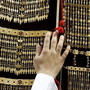 Saudi man displays jewellery at a store in Riyadh