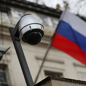 A security camera is seen, and a flag flies outside the consular section of Russia s