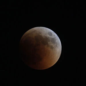 A shadow falls on the moon during a lunar eclipse as seen from Amman