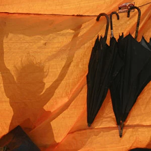 A shadow of a girl is seen outside her makeshift tent in the flood-hit area of Darbhanga