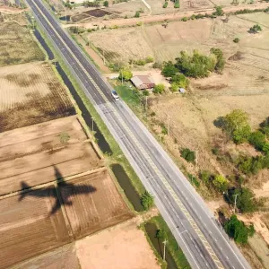 A shadow of a plane is seen near a highway road before landing at Roi Et airport A shadow of a plane is seen near a highway road before landing at Roi Et airport