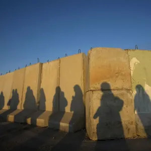Shadows of Palestinian women are seen at Qalandiya checkpoint outside Ramallah Shadows of Palestinian women are seen at Qalandiya checkpoint outside Ramallah