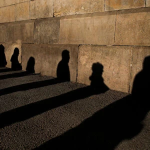 Shadows of people queuing to vote are cast on a wall during voting in Catalonia s