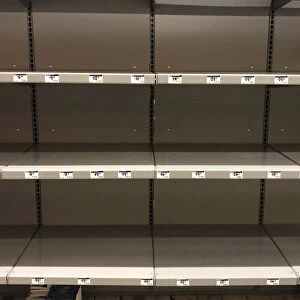 Empty shelves for headlights, lanterns and other supplies are seen at a Home Depot store