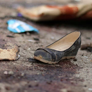 A shoe is seen near blood stains following a car bomb attack in Hasaka province