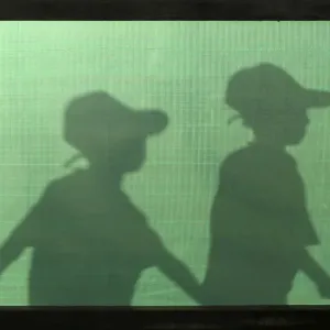 The silhouettes of Palestinian boys are seen as they arrive for a summer camp organised The silhouettes of Palestinian boys are seen as they arrive for a summer camp organised