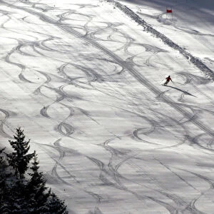 A skier enjoys his first ride down the freshly maintained slope in Fieberbrunn in austria
