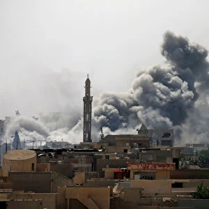 Smoke rises from an airstrike during a battle between Iraqi forces