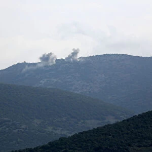 Smoke rises on the mountains as seen from Northern Afrin countryside