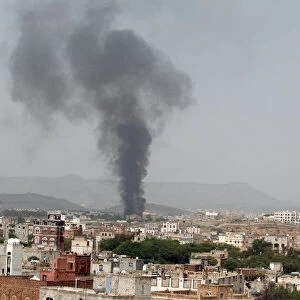 Smoke rises from a snack food factory after a Saudi-led air strike hit it in Sanaa