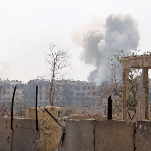 Smoke rises from Yarmouk Palestinian camp in Damascus