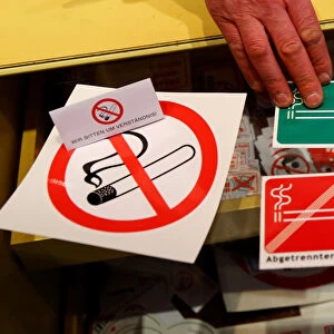 No smoking signs are seen on a table in a sign shop in Vienna