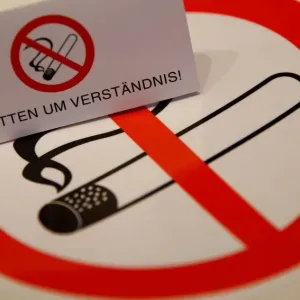 No smoking signs are seen on a table in a sign shop in Vienna No smoking signs are seen on a table in a sign shop in Vienna