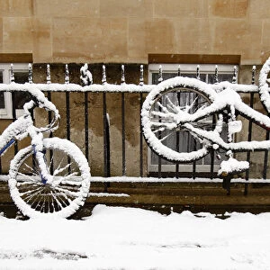 Snow-covered bikes are seen outside Corpus Christi College in Oxford, southern England
