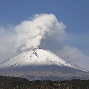 The snow-covered Popocatepetl volcano spews a cloud of steam high into the air in Puebla