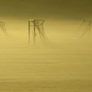 Soccer goal posts are seen in the autumn mist at Dukes Meadows in Chiswick, west London