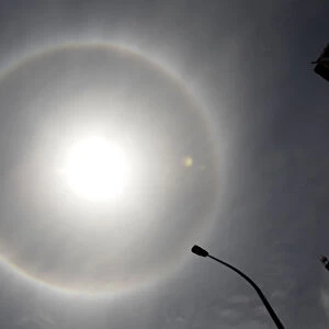 A solar halo, an optical phenomenon that appears around the Sun, is photographed in Lima