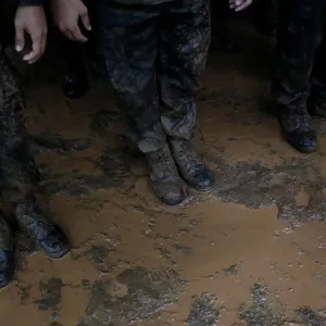 Soldiers line up near Tham Luang caves during a search for 12 members of an under-16 Soldiers line up near Tham Luang caves during a search for 12 members of an under-16