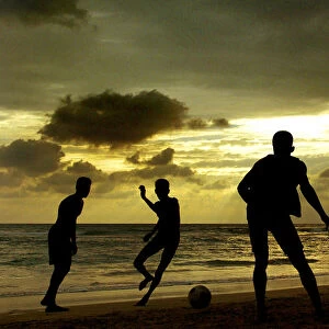 SRI LANKAN CHILDREN PLAY FOOTBALL ON BEACH AT UNAWATUNA