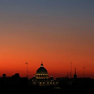 St. Peters basilica is seen at sunset from downtown Rome