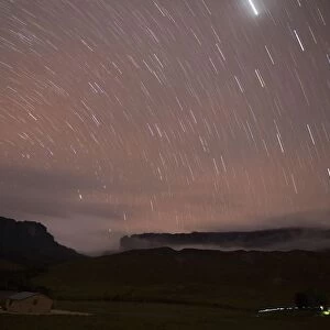 Stars are seen in the night sky over Kukenan and Roraima mounts near the Tec Camp
