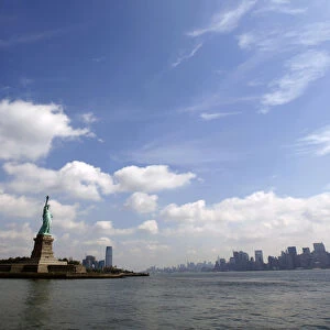 Statue of Liberty and New York City skyline seen from tour boat from New York Harbor