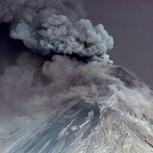 Steam rises from Fuego volcano (Volcano of Fire) as seen from San Juan Alotenango