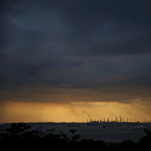 Storm clouds gather over Shells Pulau Bukom oil refinery in Singapore