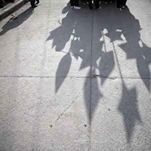 Students cast their shadows during a parade to celebrate Mothers Day in Chilapa de