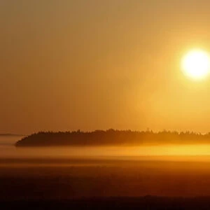 Sun rises over foggy field near the village of Khatenchytsy