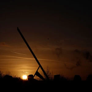The sun rises behind the Millennium Sundial in Barrow upon Soar